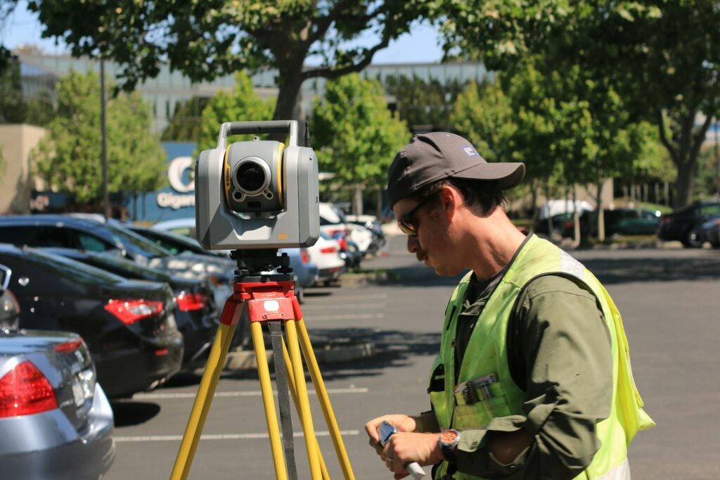 Land surveyor using a theodolite to measure property boundaries in British Columbia