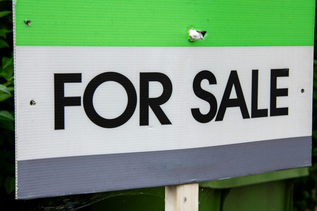 Real estate For Sale sign in front of a home, representing a seller preparing to list their property in British Columbia