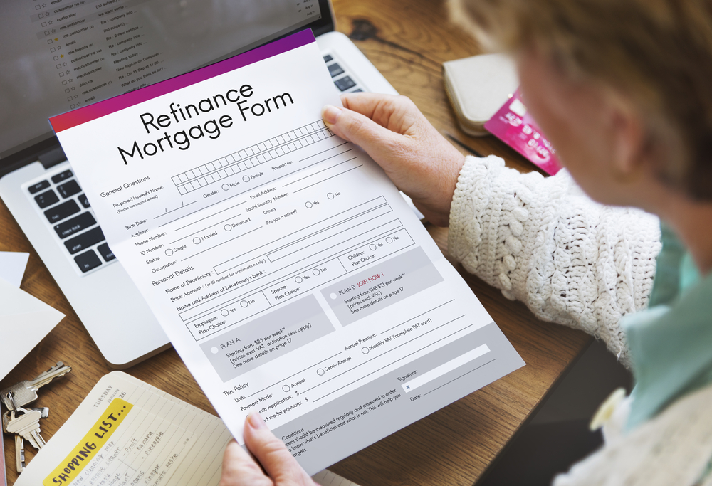 Homeowner reviewing mortgage refinancing paperwork in British Columbia